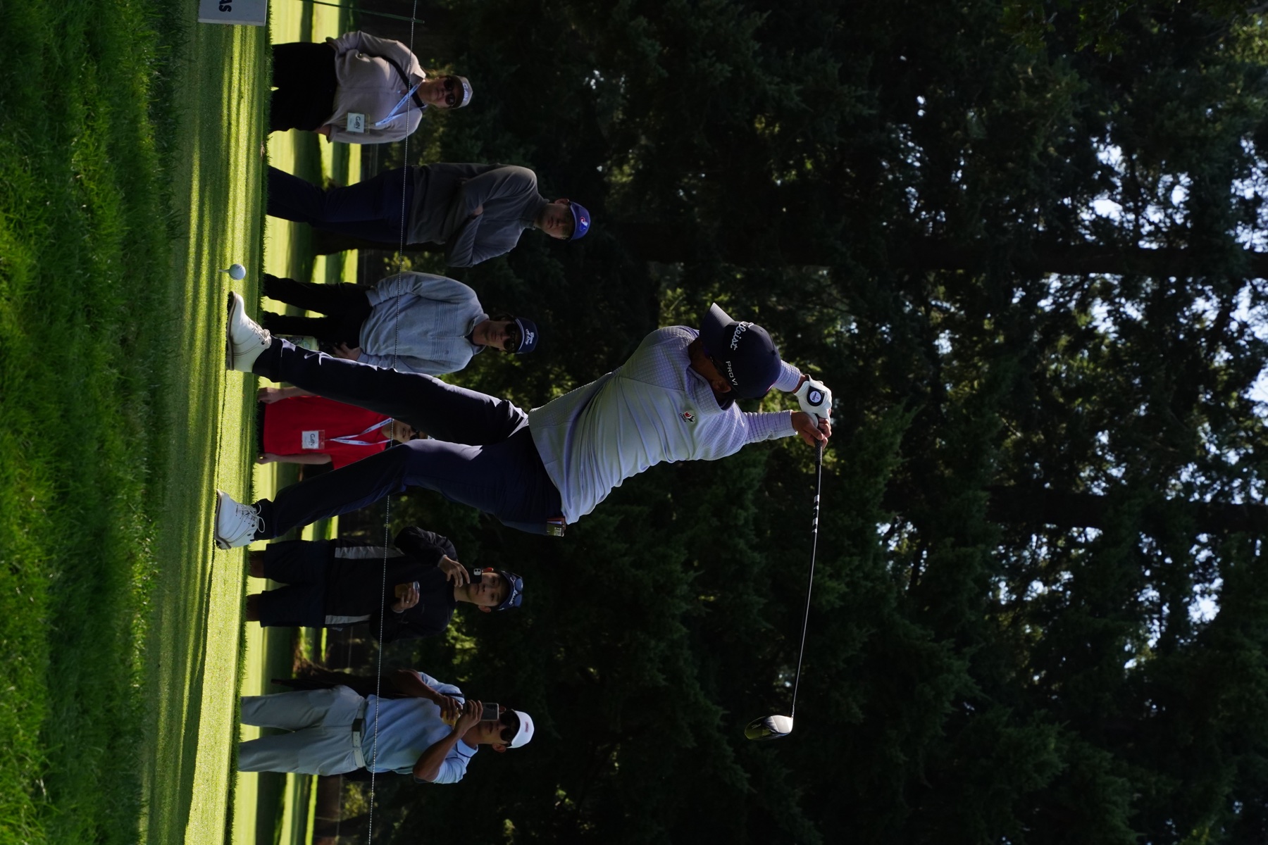 Golfer following a tee shot during tournament play
