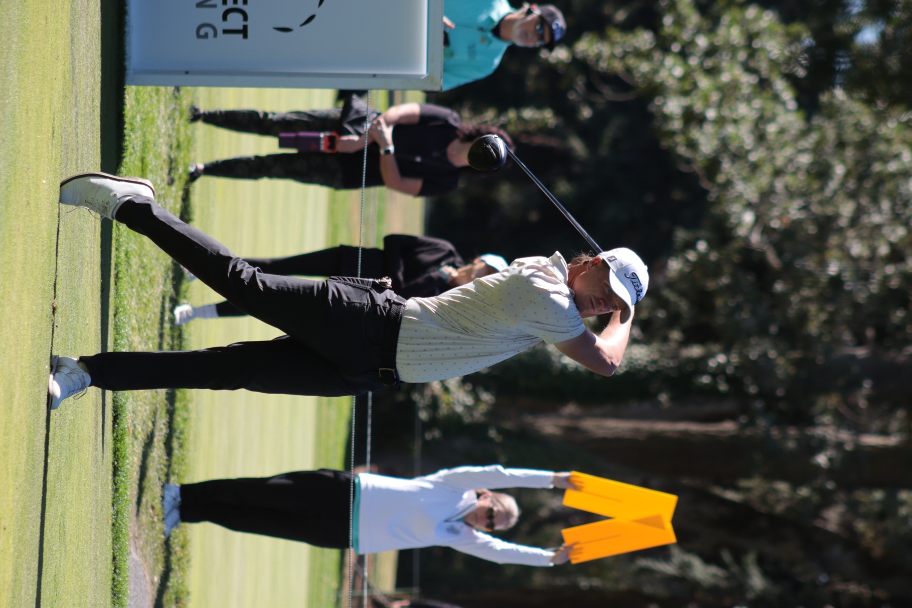 Golfer teeing off during championship play